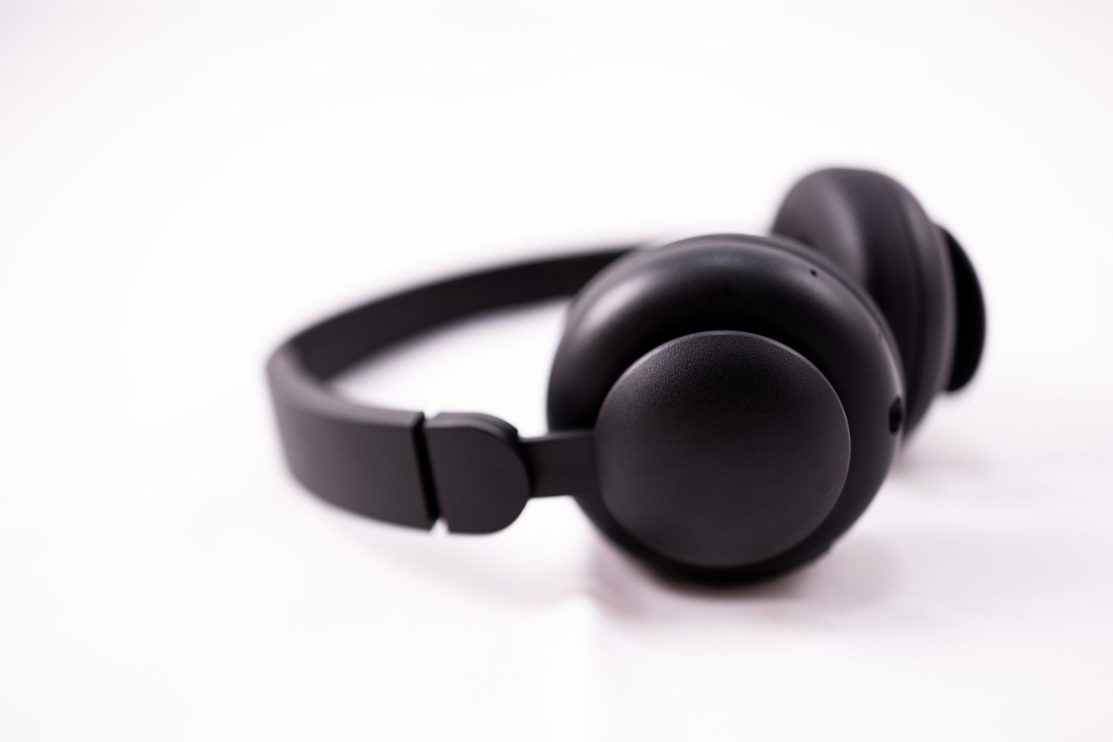 Black wireless headphones isolated on a white background for a product cutout example